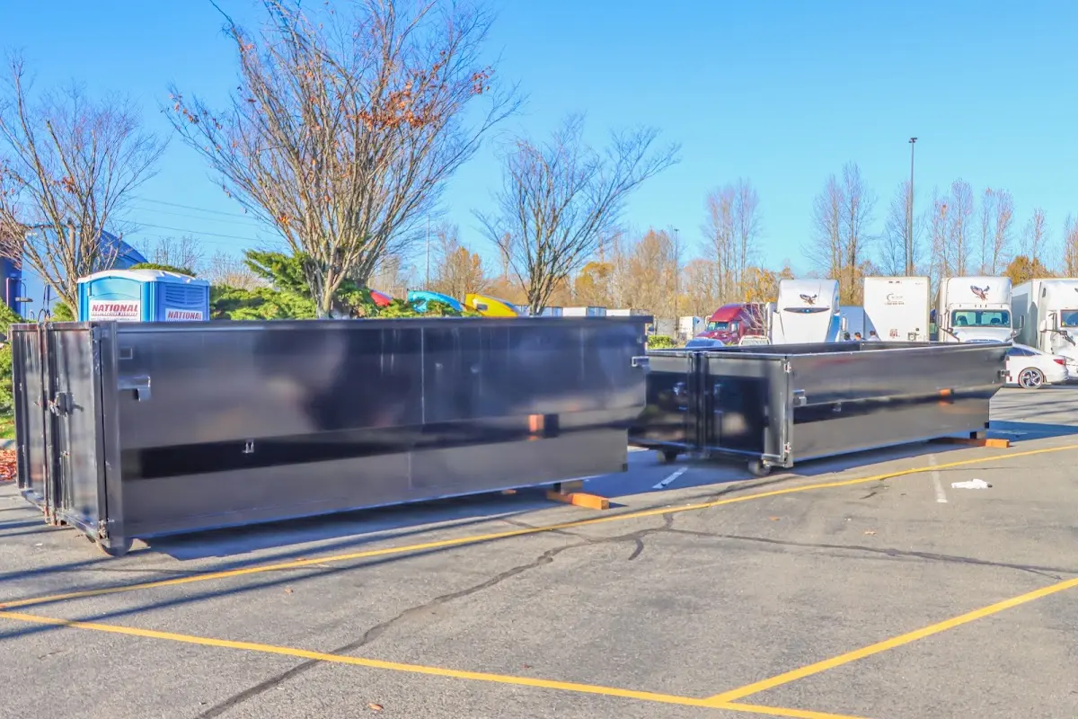 Professional dumpster rental service with roll-off container on residential driveway in Morgan City